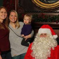 Santa posing with family of three